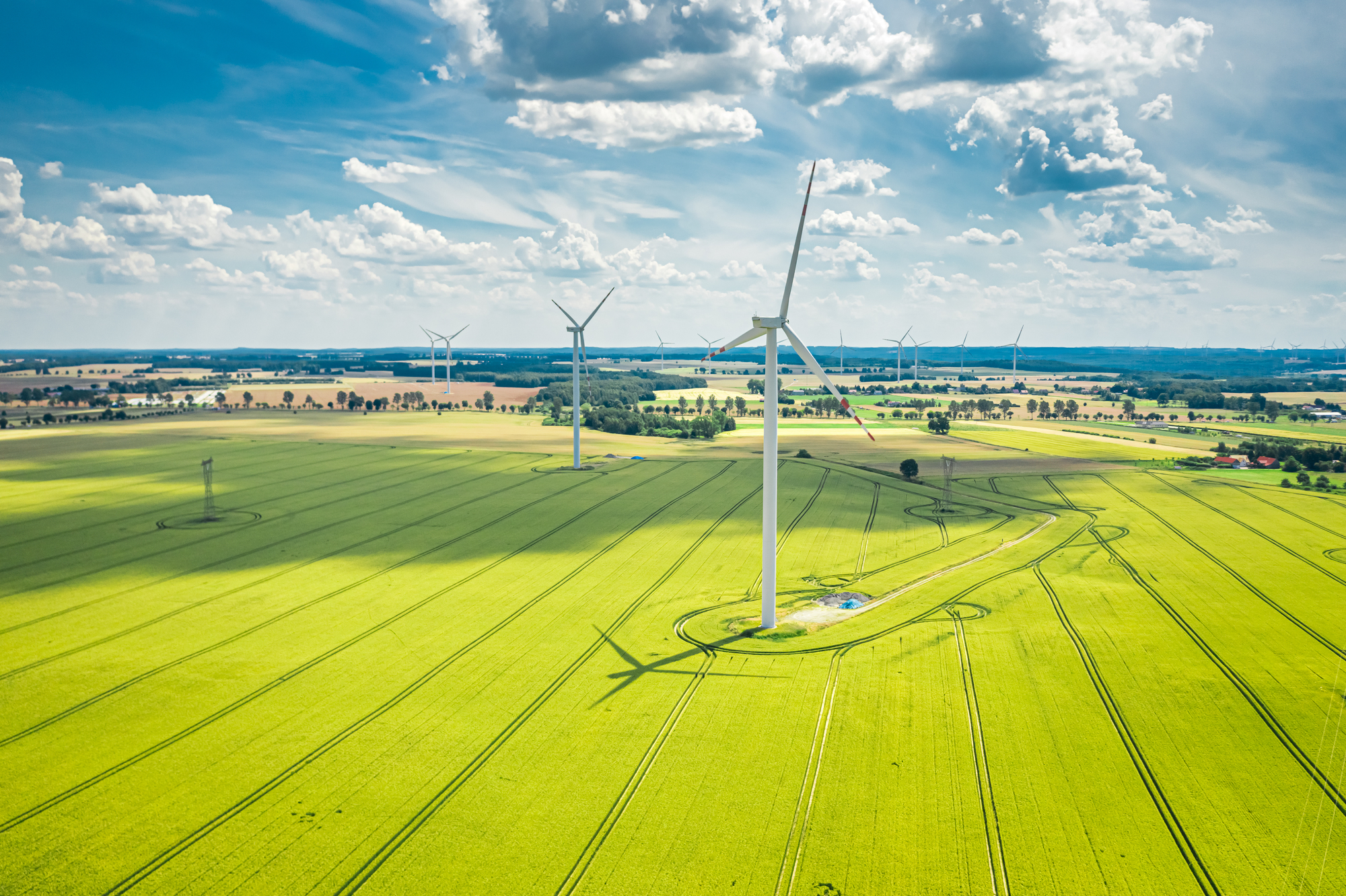 wind-turbines-on-golden-green-field-in-summer-aer-2026-01-09-06-44-07-utc-1